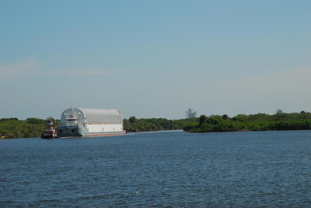 KENNEDY SPACE CENTER, FLA.  --  The Pegasus barge is towed into the turn basin in the Launch Complex 39 Area.  The barge's cargo is the external tank prepared for mission STS-118 by the Michoud Assembly Facility near New Orleans.  After docking, the tank will eventually be offloaded and moved to the Vehicle Assembly Building.  Photo credit: Jack Pfaller