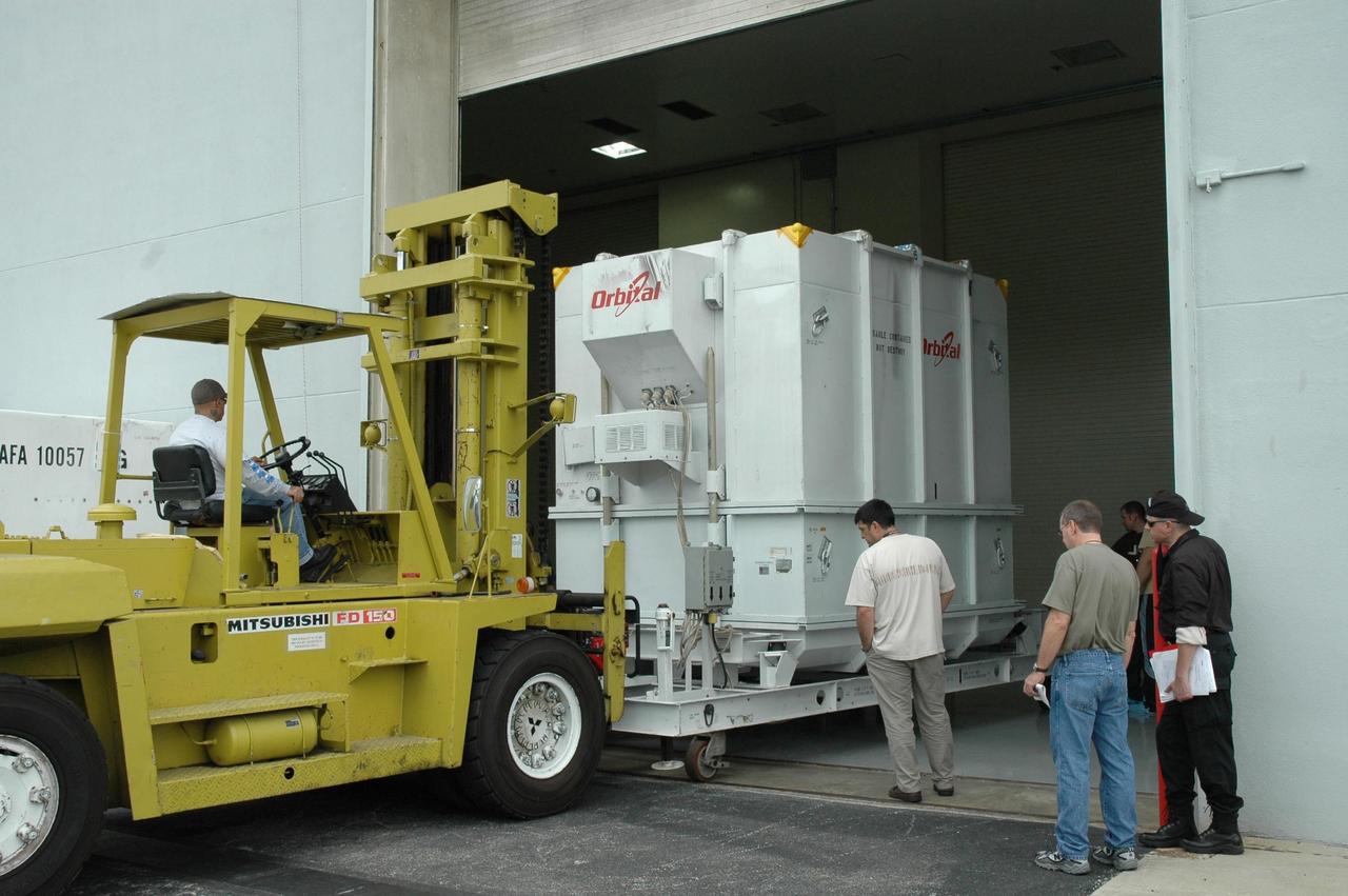 KENNEDY SPACE CENTER, FLA.  -- At Astrotech, the shipping container holding the Dawn spacecraft is moved into the high bay of the Payload Processing Facility.  The spacecraft will next be removed from the container.  Dawn's mission is to explore two of the asteroid belt's most intriguing and dissimilar occupants: asteroid Vesta and the dwarf planet Ceres.  The Dawn mission is managed by JPL, a division of the California Institute of Technology in Pasadena, for NASA's Science Mission Directorate in Washington, D.C.   Photo credit: NASA/Jim Grossmann