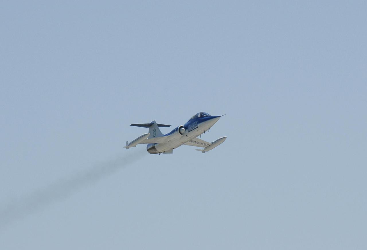 KENNEDY SPACE CENTER, FLA.  --   A Starfighter F-104 piloted by Rick Svetkoff approaches the Shuttle Landing Facility at Kennedy Space Center.  The aircraft will take part in a series of pathfinder test missions from the space shuttle runway. Two flights will generate test data to validate sonic boom assumptions about the potential impacts of suborbital and orbital commercial spaceflight from the facility. NASA is assessing the environmental impact of such flights. Starfighters Inc. of Clearwater, Fla., will perform the flights to help in assessing suborbital space launch trajectories from the runway and paving the way for future commercial space tourism and research flights from the facility. Photo credit: NASA/Kim Shiflett