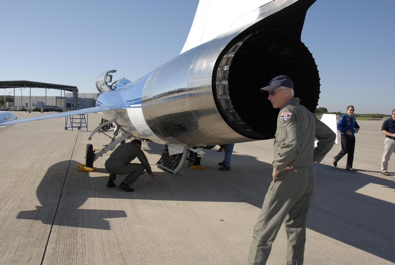 KENNEDY SPACE CENTER, FLA.  --   On the KSC Shuttle Landing Facility, a Starfighter F-104 aircraft is being prepared for test flights.  Behind the plane is Dave Waldrop, co-pilot. The aircraft is taking part in a series of pathfinder test missions from the space shuttle runway. Two flights will generate test data to validate sonic boom assumptions about the potential impacts of suborbital and orbital commercial spaceflight from the facility. NASA is assessing the environmental impact of such flights.  Starfighters Inc. of Clearwater, Fla., will perform the flights to help in assessing suborbital space launch trajectories from the runway and paving the way for future commercial space tourism and research flights from the facility.  Photo credit: NASA/Kim Shiflett