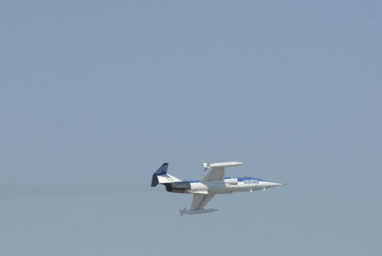 KENNEDY SPACE CENTER, FLA.  --  The Starfighter F-104 banks for a turn after taking off from the KSC Shuttle Landing Facility.  The pilot is Rick Svetkoff; the co-pilot is Dave Waldrop. The aircraft is taking part in a series of pathfinder test missions from the space shuttle runway. Two flights will generate test data to validate sonic boom assumptions about the potential impacts of suborbital and orbital commercial spaceflight from the facility. NASA is assessing the environmental impact of such flights.  Starfighters Inc. of Clearwater, Fla., will perform the flights to help in assessing suborbital space launch trajectories from the runway and paving the way for future commercial space tourism and research flights from the facility.  Photo credit: NASA/Kim Shiflett