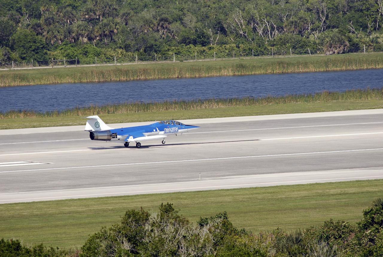 KENNEDY SPACE CENTER, FLA.  --  The Starfighter F-104 lands on the runway at the KSC Shuttle Landing Facility after its test flight.  The aircraft is taking part in a series of pathfinder test missions from the space shuttle runway. Two flights will generate test data to validate sonic boom assumptions about the potential impacts of suborbital and orbital commercial spaceflight from the facility. NASA is assessing the environmental impact of such flights.  Starfighters Inc. of Clearwater, Fla., will perform the flights to help in assessing suborbital space launch trajectories from the runway and paving the way for future commercial space tourism and research flights from the facility.  Photo credit: NASA/Kim Shiflett