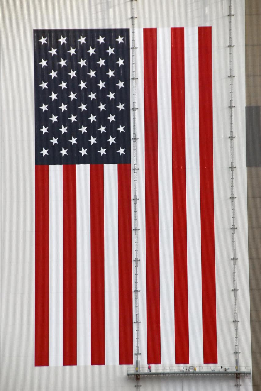KENNEDY SPACE CENTER, FLA.  -- The finishing touches are painted on the American flag that embellishes the southwest side of the Vehicle Assembly Building at NASA's Kennedy Space Center.  The flag and the NASA logo, which is on the southeast side, have both been refreshed with new paint. The flag and logo were last painted in 1998, honoring NASA's 40th anniversary. The flag spans an area 209 feet by 110 feet, or about 23, 437 square feet. Each stripe is 9 feet wide and each star is 6 feet in diameter.  The logo, which is known as the "meatball," measures 110 feet by 132 feet, or about 12,300 square feet. The building stands 525-feet tall.  Photo credit: NASA/George Shelton