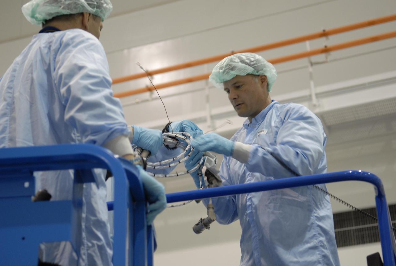 KENNEDY SPACE CENTER, FLA.  --  In the Space Station Processing Facility, STS-120 Mission Specialists Paolo Angelo Nespoli (left) and Douglas H. Wheelock practice using some of the equipment for the Node 2, another element to be added to the International Space Station.  They and other crew members are at KSC for equipment familiarization.  Node 2 will provide a passageway between three station science experiment facilities: the U.S. Destiny Laboratory, the Kibo Japanese Experiment Module, and the European Columbus Laboratory.  STS-120 is targeted for launch on October 20.   Photo credit: NASA/Kim Shiflett