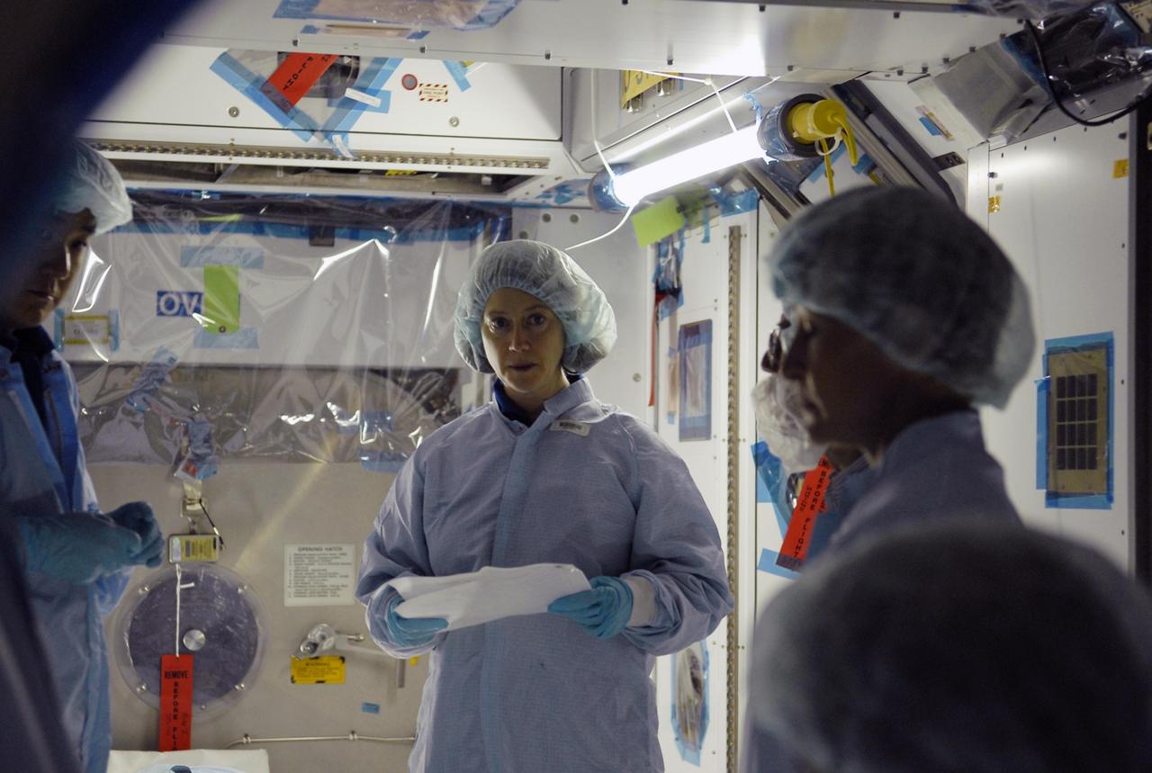KENNEDY SPACE CENTER, FLA.  --  In In the Space Station Processing Facility, STS-120 Commander Pamela Melroy (center) learns more about the Node 2, another element to be added to the International Space Station.  She and other crew members are at KSC for equipment familiarization.  Node 2 will provide a passageway between three station science experiment facilities: the U.S. Destiny Laboratory, the Kibo Japanese Experiment Module, and the European Columbus Laboratory.  STS-120 is targeted for launch on October 20.   Photo credit: NASA/Kim Shiflett