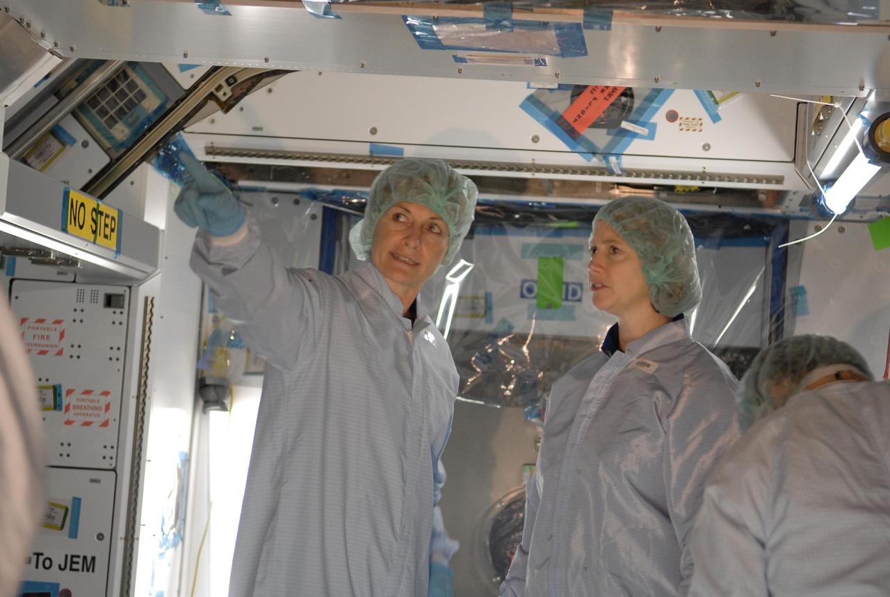 KENNEDY SPACE CENTER, FLA. -- In the Space Station Processing Facility, STS-120 Commander Pamela Melroy (right) learns more about the Node 2, another element to be added to the International Space Station. With her is astronaut Peggy Whitson, who served on Expedition 5 aboard the space station. During her 6-month stay aboard the space station, Dr. Whitson installed the Mobile Base System, the S1 truss segment, and the P1 truss segment. She and other crew members are at KSC for equipment familiarization. Node 2 will provide a passageway between three station science experiment facilities: the U.S. Destiny Laboratory, the Kibo Japanese Experiment Module, and the European Columbus Laboratory. STS-120 is targeted for launch on October 20. Photo credit: NASA/Kim Shiflett