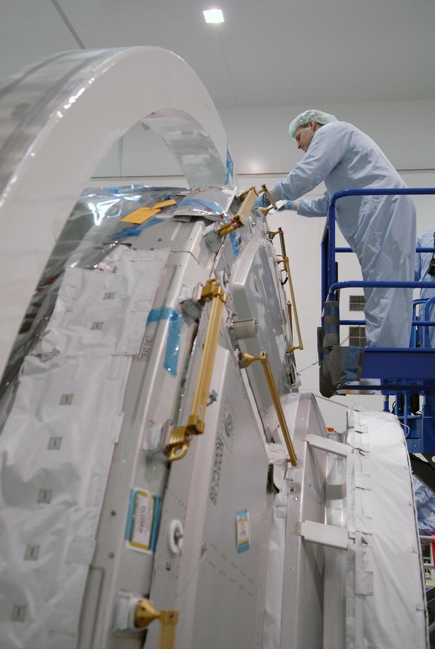 KENNEDY SPACE CENTER, FLA. -- In the Space Station Processing Facility, STS-120 Mission Specialist Scott Parazynski becomes familiar with the Node 2, another element to be added to the International Space Station. He and other crew members are at KSC for equipment familiarization. Node 2 will provide a passageway between three station science experiment facilities: the U.S. Destiny Laboratory, the Kibo Japanese Experiment Module, and the European Columbus Laboratory. STS-120 is targeted for launch on October 20. Photo credit: NASA/Kim Shiflett