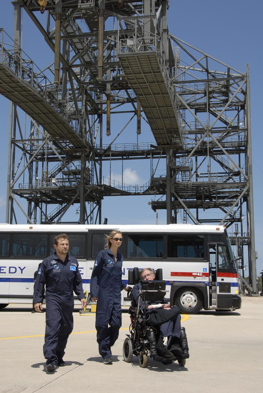 KENNEDY SPACE CENTER, FLA. -- At the Kennedy Space Center Shuttle Landing Facility, noted physicist Stephen Hawking, in the wheelchair, arrives at the runway for his first zero-gravity flight. The flight will be aboard a modified Boeing 727 aircraft owned by Zero Gravity Corp., a commercial company licensed to provide the public with weightless flight experiences.  At left is Peter Diamandis, founder of the Zero Gravity Corp. At center is Nicola O'Brien, a nurse practitioner who is Hawking's aide.  Hawking developed amyotrophic lateral sclerosis disease in the 1960s, a type of motor neuron disease which would cost him the loss of almost all neuromuscular control. At the celebration of his 65th birthday on January 8 this year, Hawking announced his plans for a zero-gravity flight to prepare for a sub-orbital space flight in 2009 on Virgin Galactic's space service.  Photo credit: NASA/Kim Shiflett