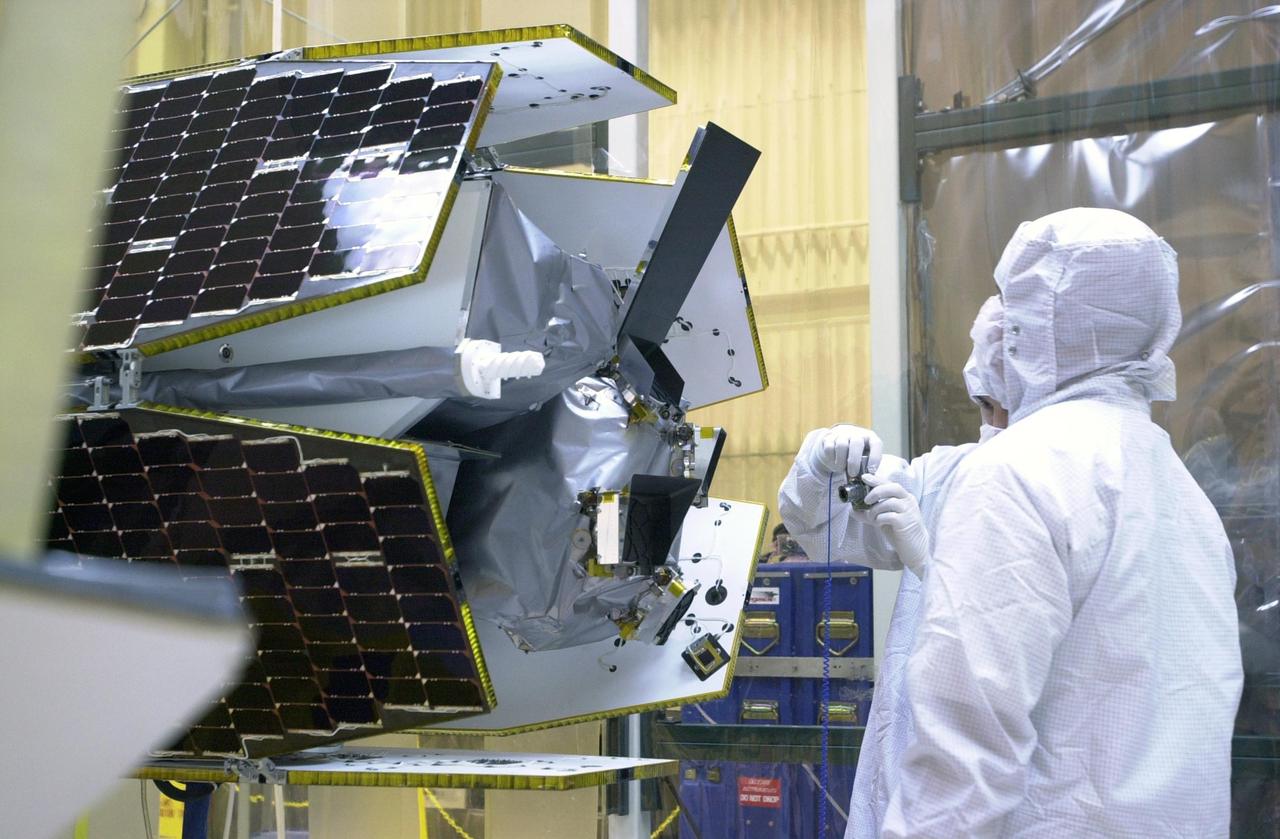 KENNEDY SPACE CENTER, FLA. -- At Vandenberg Air Force Base in California, technicians prepare the AIM spacecraft for fairing installation. The fairing is a molded structure that fits around the spacecraft and forms an aerodynamically smooth nose cone, protecting the spacecraft during launch. Launch will be from a Pegasus XL rocket, carried and released by Orbital Sciences L-1011 jet aircraft. AIM, which stands for Aeronomy of Ice in the Mesosphere, is being prepared for integrated testing and a flight simulation. The AIM spacecraft will fly three instruments designed to study polar mesospheric clouds located at the edge of space, 50 miles above the Earth's surface in the coldest part of the planet's atmosphere. The mission's primary goal is to explain why these clouds form and what has caused them to become brighter and more numerous and appear at lower latitudes in recent years. AIM's results will provide the basis for the study of long-term variability in the mesospheric climate and its relationship to global climate change. Launch is scheduled for April 25.