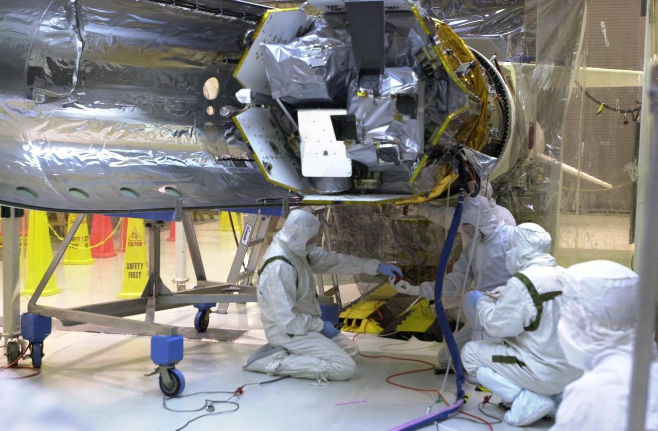 KENNEDY SPACE CENTER, FLA. -- At Vandenberg Air Force Base in California, technicians prepare the AIM spacecraft for fairing installation. The fairing is a molded structure that fits around the spacecraft and forms an aerodynamically smooth nose cone, protecting the spacecraft during launch. Launch will be from a Pegasus XL rocket, carried and released by Orbital Sciences L-1011 jet aircraft. AIM, which stands for Aeronomy of Ice in the Mesosphere, is being prepared for integrated testing and a flight simulation. The AIM spacecraft will fly three instruments designed to study polar mesospheric clouds located at the edge of space, 50 miles above the Earth's surface in the coldest part of the planet's atmosphere. The mission's primary goal is to explain why these clouds form and what has caused them to become brighter and more numerous and appear at lower latitudes in recent years. AIM's results will provide the basis for the study of long-term variability in the mesospheric climate and its relationship to global climate change. Launch is scheduled for April 25.