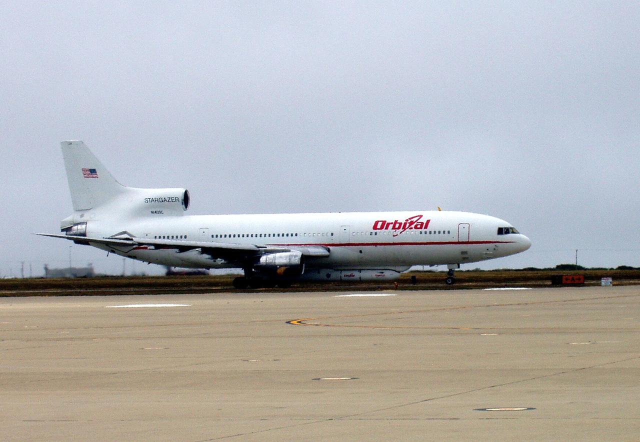 KENNEDY SPACE CENTER, FLA. -- On a runway at Vandenberg Air Force Base in California, the Orbital Sciences Stargazer L-1011 aircraft is ready for takeoff with its underbelly cargo of the Pegasus XL rocket-AIM spacecraft. The aircraft will release the Pegasus XL rocket at a drop point over the Pacific Ocean, 100 miles offshore west-southwest of Point Sur, Calif. AIM, which stands for Aeronomy of Ice in the Mesosphere, is being prepared for integrated testing and a flight simulation. The AIM spacecraft will fly three instruments designed to study polar mesospheric clouds located at the edge of space, 50 miles above the Earth's surface in the coldest part of the planet's atmosphere. The mission's primary goal is to explain why these clouds form and what has caused them to become brighter and more numerous and appear at lower latitudes in recent years. AIM's results will provide the basis for the study of long-term variability in the mesospheric climate and its relationship to global climate change. Launch is scheduled for April 25. Photo credit: NASA/Tim Gordon