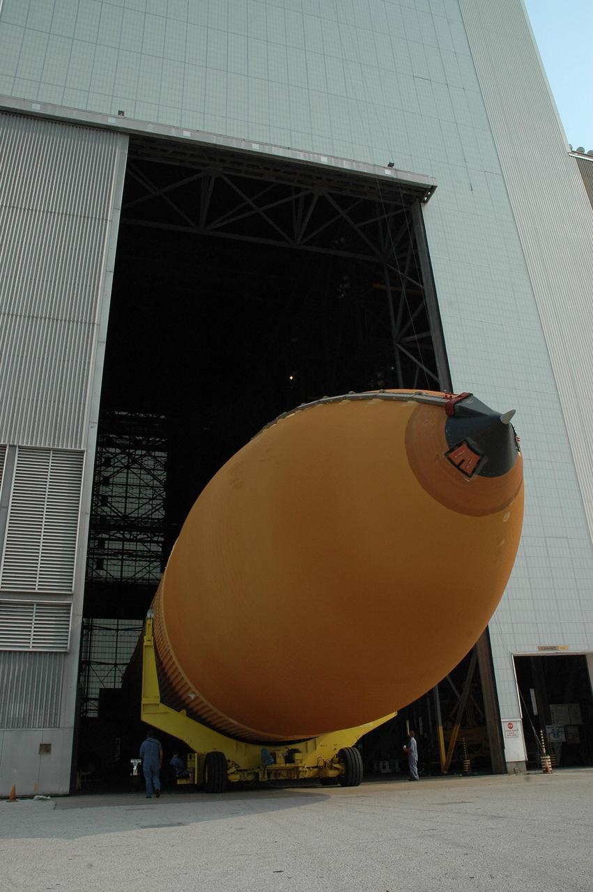 KENNEDY SPACE CENTER, FLA. --  Aboard its transporter, external tank No. 117 moves into the transfer aisle of the Vehicle Assembly Building.  The tank was offloaded from the Pegasus barge in the nearby turn basin. ET-117 arrived aboard the barge after its voyage around the Florida Peninsula from the Michoud Assembly Facility near New Orleans. The tank is slated for mission STS-118, which is targeted for launch in early August.  ET-117 will be moved into a checkout cell in high bay 2 of the VAB for processing.  Photo credit: NASA/Jack Pfaller