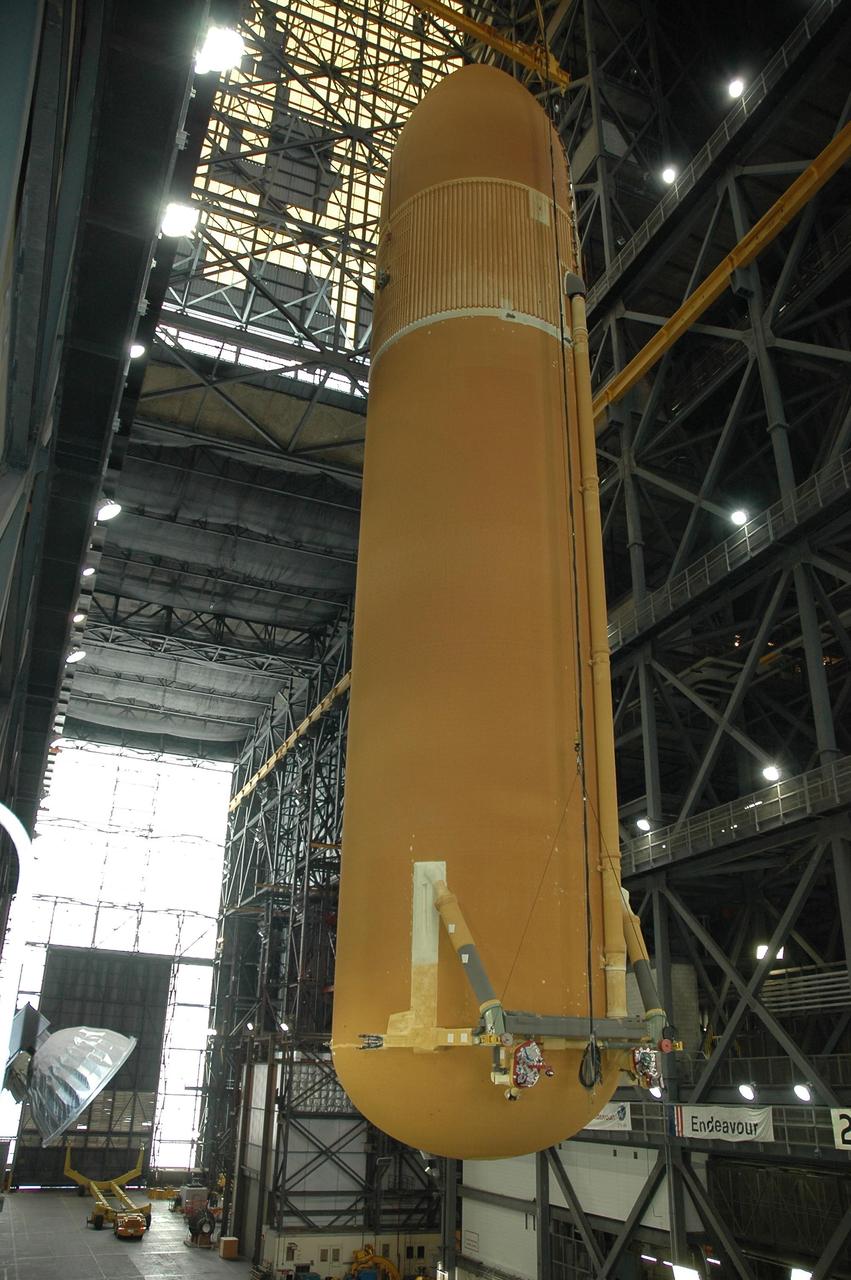KENNEDY SPACE CENTER, FLA. -- In the Vehicle Assembly Building, external tank No. 117 is lifted into the upper regions in order to move it over a crossbeam into the checkout cell in high bay 2 for processing. ET-117 arrived aboard the Pegasus barge after its voyage around the Florida Peninsula from the Michoud Assembly Facility near New Orleans. The tank is slated for mission STS-118, which is targeted for launch in early August. Photo credit: NASA/Jack Pfaller