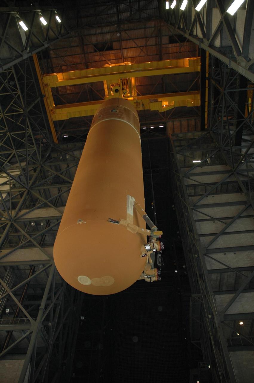 KENNEDY SPACE CENTER, FLA. -- Seen from below, external tank No. 117 is lifted into the upper regions of the Vehicle Assembly Building in order to move it over a crossbeam into the checkout cell in high bay 2 for processing. ET-117 arrived aboard the Pegasus barge after its voyage around the Florida Peninsula from the Michoud Assembly Facility near New Orleans. The tank is slated for mission STS-118, which is targeted for launch in early August. Photo credit: NASA/Jack Pfaller