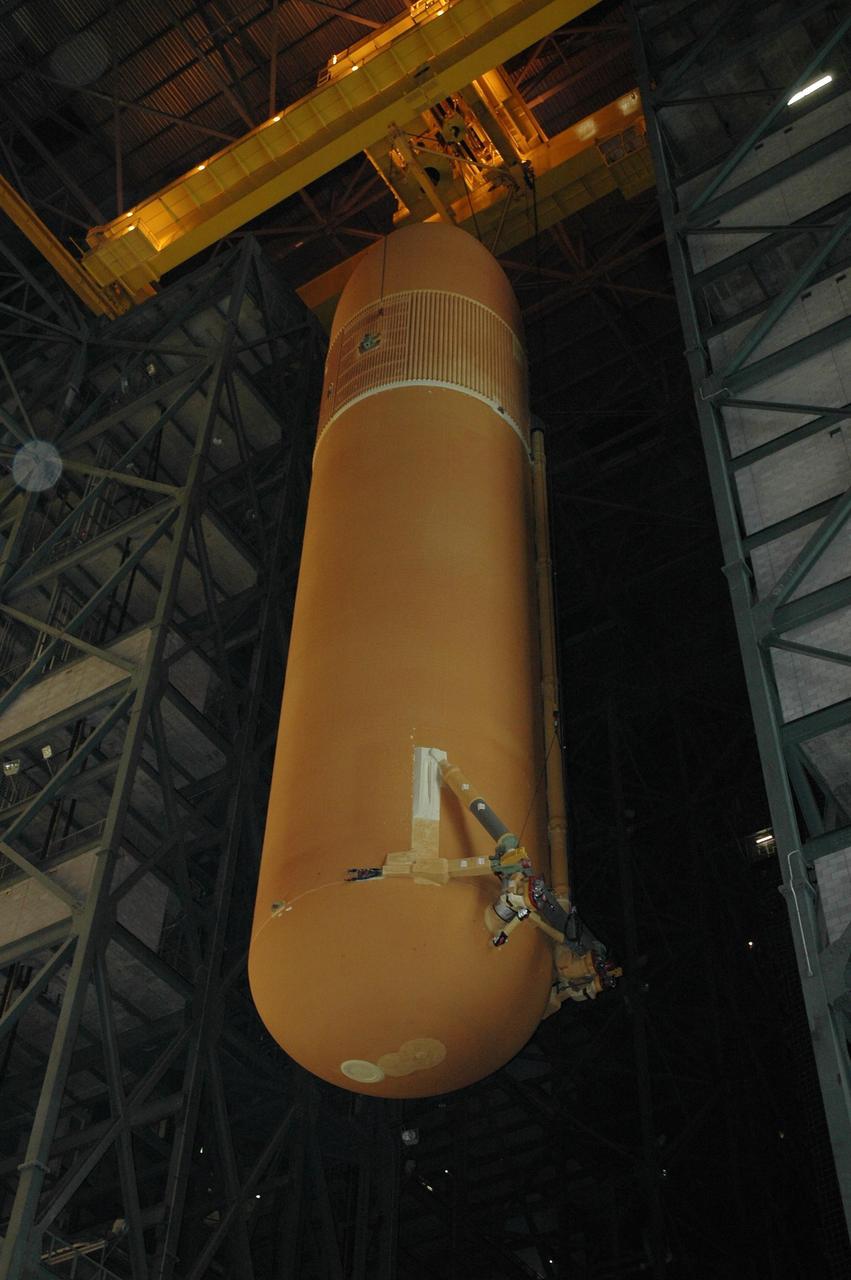 KENNEDY SPACE CENTER, FLA. -- In the Vehicle Assembly Building, the suspended external tank No. 117 reaches the level needed to move it over the crossbeam into the checkout cell in high bay 2 for processing. ET-117 arrived aboard the Pegasus barge after its voyage around the Florida Peninsula from the Michoud Assembly Facility near New Orleans. The tank is slated for mission STS-118, which is targeted for launch in early August. Photo credit: NASA/Jack Pfaller