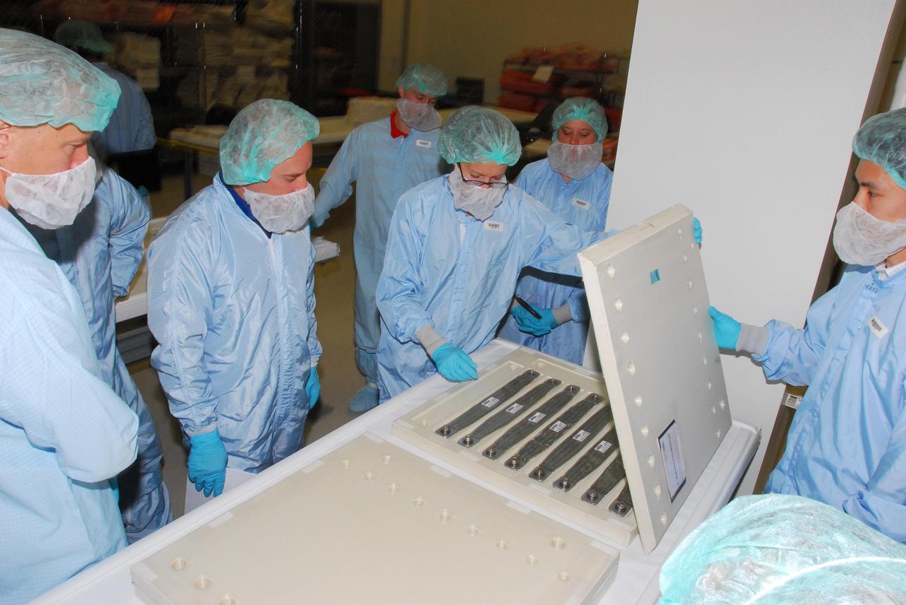 KENNEDY SPACE CENTER, FLA. -- During a bench review in the Space Station Processing Facility, astronauts dressed in bunny suits get a close look at hardware they will be taking into and using in orbit. The astronauts are slated to join future expedition crews aboard the International Space Station. Among those participating in the review are Mission Specialist Garrett Reisman, who will fly on mission STS-123 in 2008, Koichi Wakata, who will fly on mission STS-126 in 2008, and Tim Kopra, who is a backup for Reisman. Photo credit: NASA/George Shelton