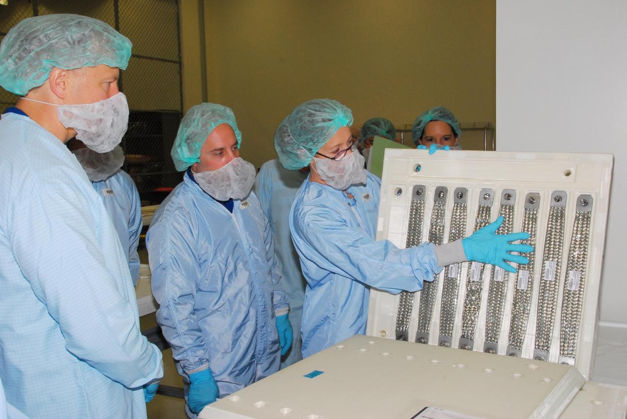 KENNEDY SPACE CENTER, FLA. -- During a bench review in the Space Station Processing Facility, astronauts dressed in bunny suits get a close look at hardware they will be taking into and using in orbit. The astronauts are slated to join future expedition crews aboard the International Space Station. Among those participating in the review are Mission Specialist Garrett Reisman, who will fly on mission STS-123, Koichi Wakata, who will fly on mission STS-126, and Tim Kopra, who is a backup for Reisman. Photo credit: NASA/George Shelton