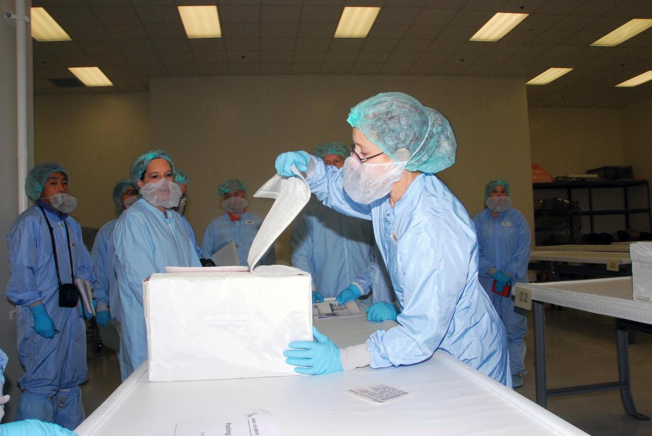 KENNEDY SPACE CENTER, FLA. -- During a bench review in the Space Station Processing Facility, astronauts, in the background, get a close look at hardware they will be taking into and using in orbit. The astronauts are slated to join future expedition crews aboard the International Space Station. Among those participating in the review are Mission Specialist Garrett Reisman, who will fly on mission STS-123, Koichi Wakata, who will fly on mission STS-126, and Tim Kopra, who is a backup for Reisman. Photo credit: NASA/George Shelton