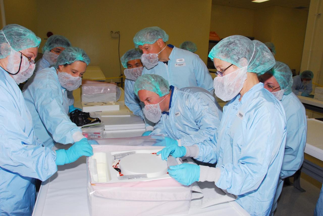 KENNEDY SPACE CENTER, FLA. -- During a bench review in the Space Station Processing Facility, astronauts (right side, from back) Koicki Wakata, Tim Kopra and Garrett Reisman get a close look at hardware they will be taking into and using in orbit. Reisman is slated to join Expedition 16 aboard the International Space Station in 2008, flying on mission STS-123; Kopra is his backup. Wakata, with the Japanese Aerospace and Exploration Agency, will join the Expedition 18 crew, flying on mission STS-126. Photo credit: NASA/George Shelton