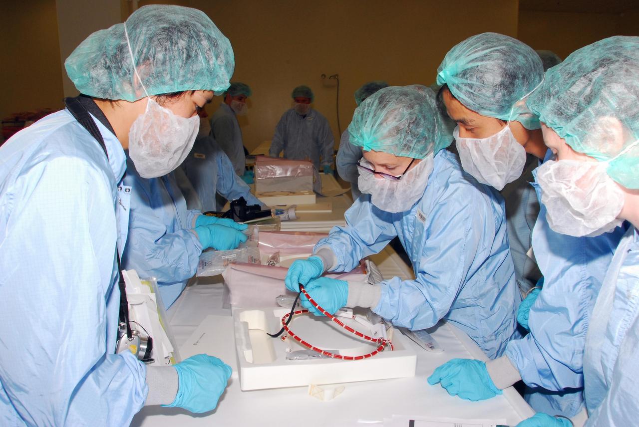 KENNEDY SPACE CENTER, FLA. -- During a bench review in the Space Station Processing Facility, astronaut (at left) Koicki Wakata gets a close look at hardware that will be used in orbit.  Wakata, with the Japanese Aerospace and Exploration Agency, will join the Expedition 18 crew in 2008, flying on mission STS-126.  Photo credit: NASA/George Shelton