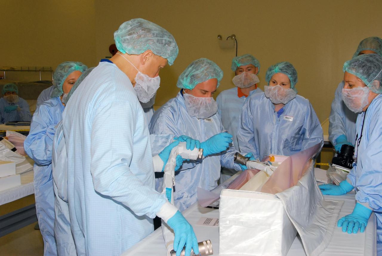 KENNEDY SPACE CENTER, FLA. -- During a bench review in the Space Station Processing Facility, astronauts (at left) Tim Kopra and Garrett Reisman get hands-on experience with hardware they will be taking into and using in orbit. Reisman is slated to join Expedition 16 aboard the International Space Station in 2008, flying on mission STS-123; Kopra is his backup. Photo credit: NASA/George Shelton