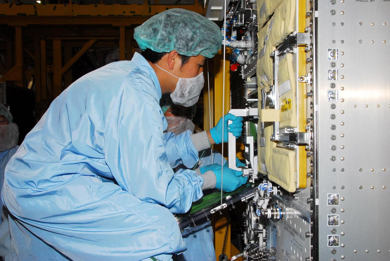 KENNEDY SPACE CENTER, FLA. -- During a bench review in the Space Station Processing Facility, astronaut Koicki Wakata gets hands-on experience on hardware he will be using in orbit.  Wakata, with the Japanese Aerospace and Exploration Agency, will join the Expedition 18 crew in 2008, flying on mission STS-126.  Photo credit: NASA/George Shelton