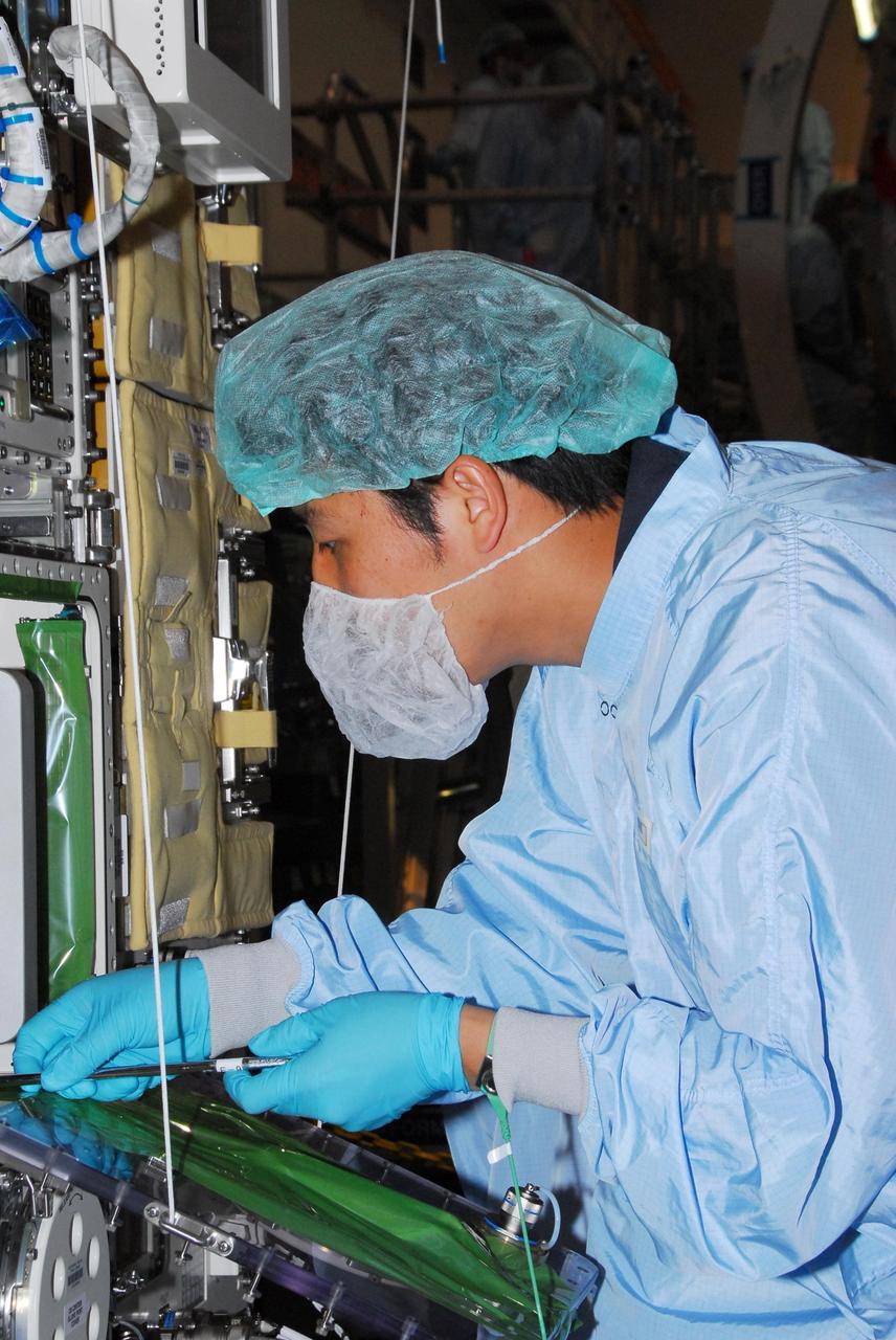 KENNEDY SPACE CENTER, FLA. -- During a bench review in the Space Station Processing Facility, astronaut Koicki Wakata gets hands-on experience on hardware he will be using in orbit.  Wakata, with the Japanese Aerospace and Exploration Agency, will join the Expedition 18 crew in 2008, flying on mission STS-126.  Photo credit: NASA/George Shelton
