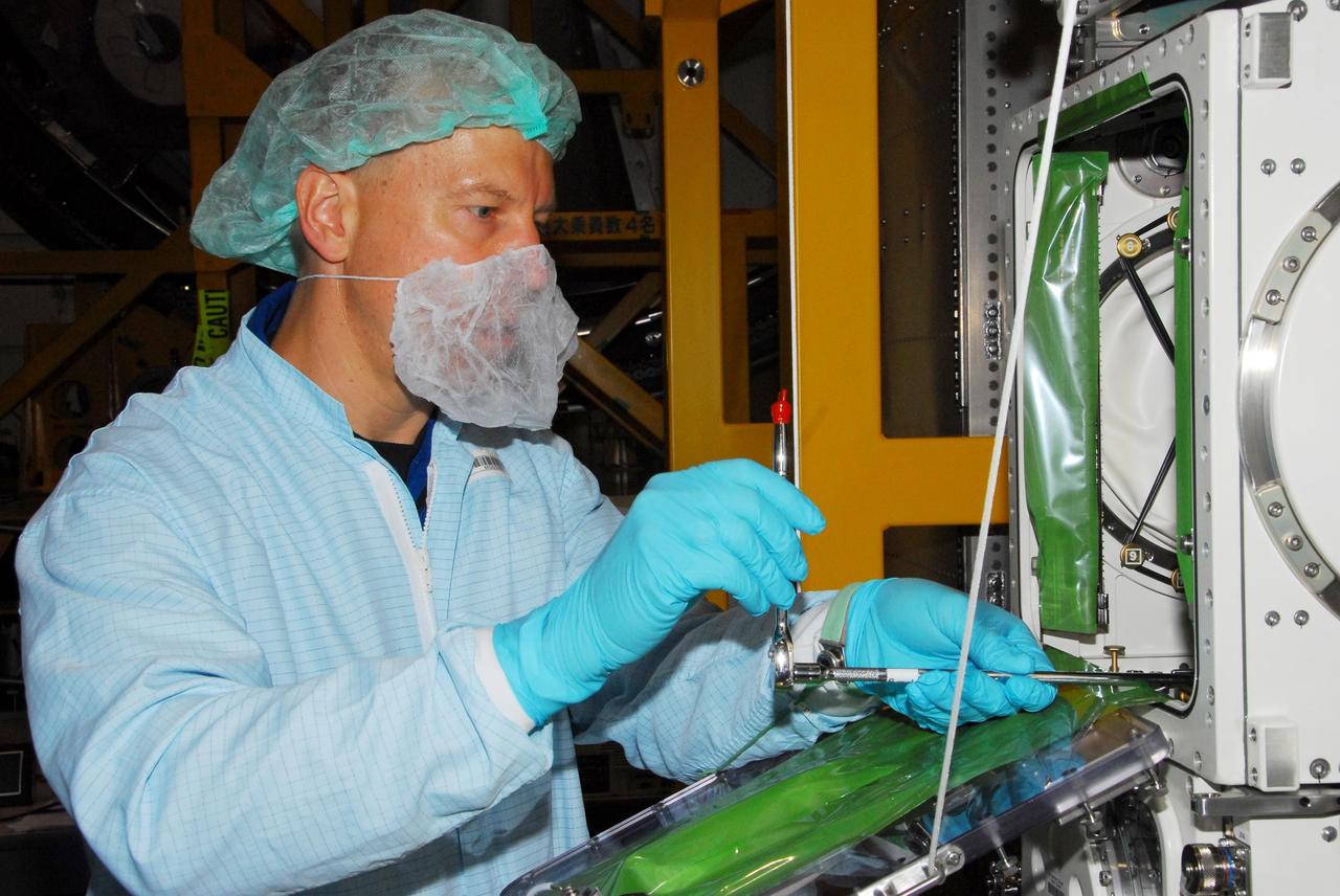 KENNEDY SPACE CENTER, FLA. -- During a bench review in the Space Station Processing Facility, astronaut Tim Kopra gets hands-on experience on hardware he could be using in orbit. Kopra is backup for Garrett Reisman, who will join the Expedition 16 crew on the International Space Station in 2008. Reisman will fly on mission STS-123 to the station. Photo credit: NASA/George Shelton