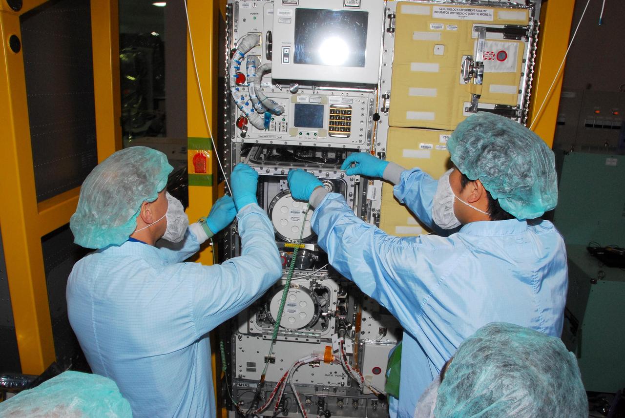 KENNEDY SPACE CENTER, FLA. -- During a bench review in the Space Station Processing Facility, astronauts Garrett Reisman (left) and Koichi Wakata get hands-on experience on hardware they will be taking into and using in orbit. Reisman will join the Expedition 16 crew on the International Space Station in 2008, flying on mission STS-123. Wakata, with the Japanese Aerospace and Exploration Agency, will join the Expedition 18 crew in 2008, flying on mission STS-126. Photo credit: NASA/George Shelton