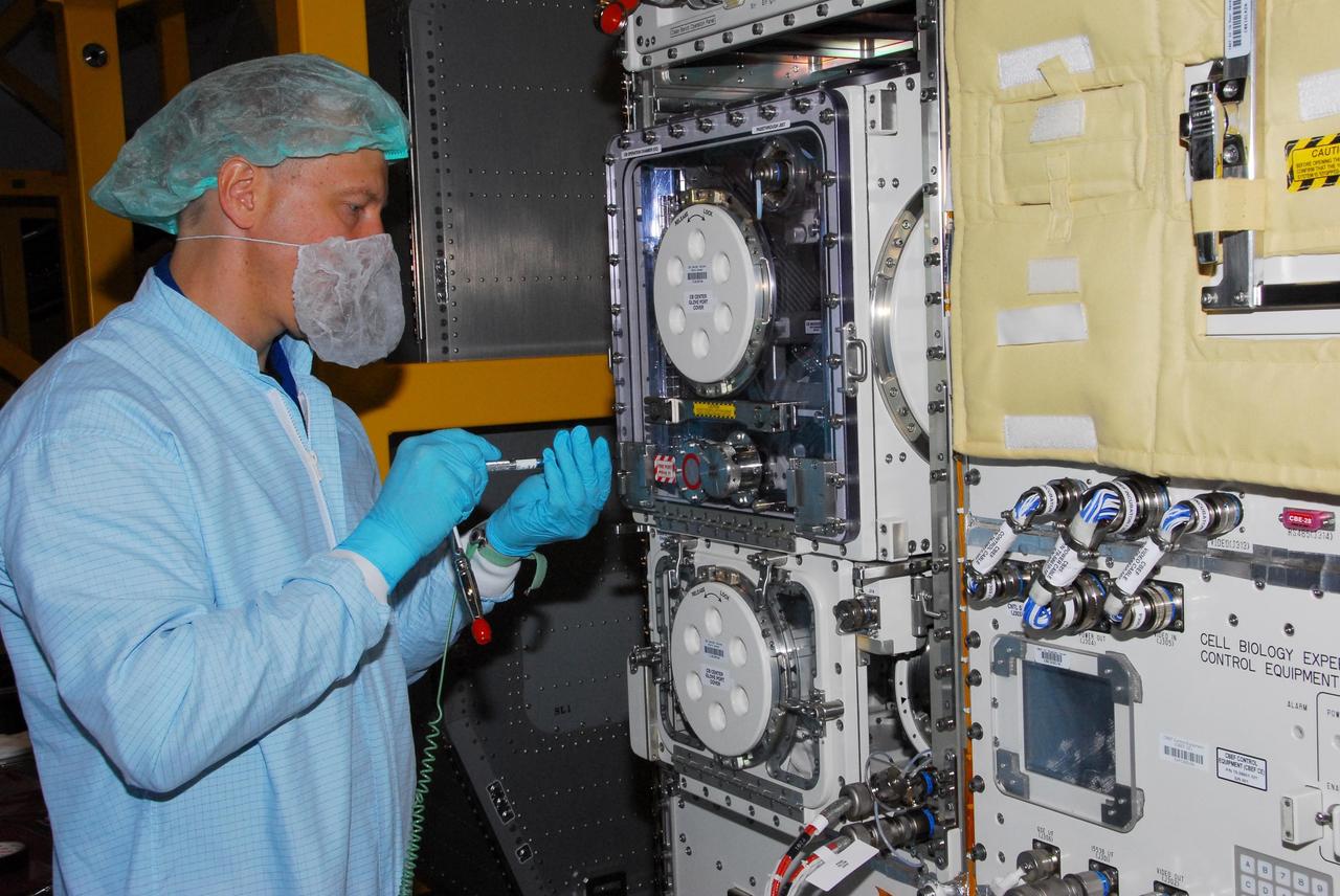 KENNEDY SPACE CENTER, FLA. -- During a bench review in the Space Station Processing Facility, astronaut Tim Kopra gets hands-on experience on hardware he could be using in orbit. Kopra is backup for Garrett Reisman, who will join the Expedition 16 crew on the International Space Station in 2008. Reisman will fly on mission STS-123 to the station. Photo credit: NASA/George Shelton