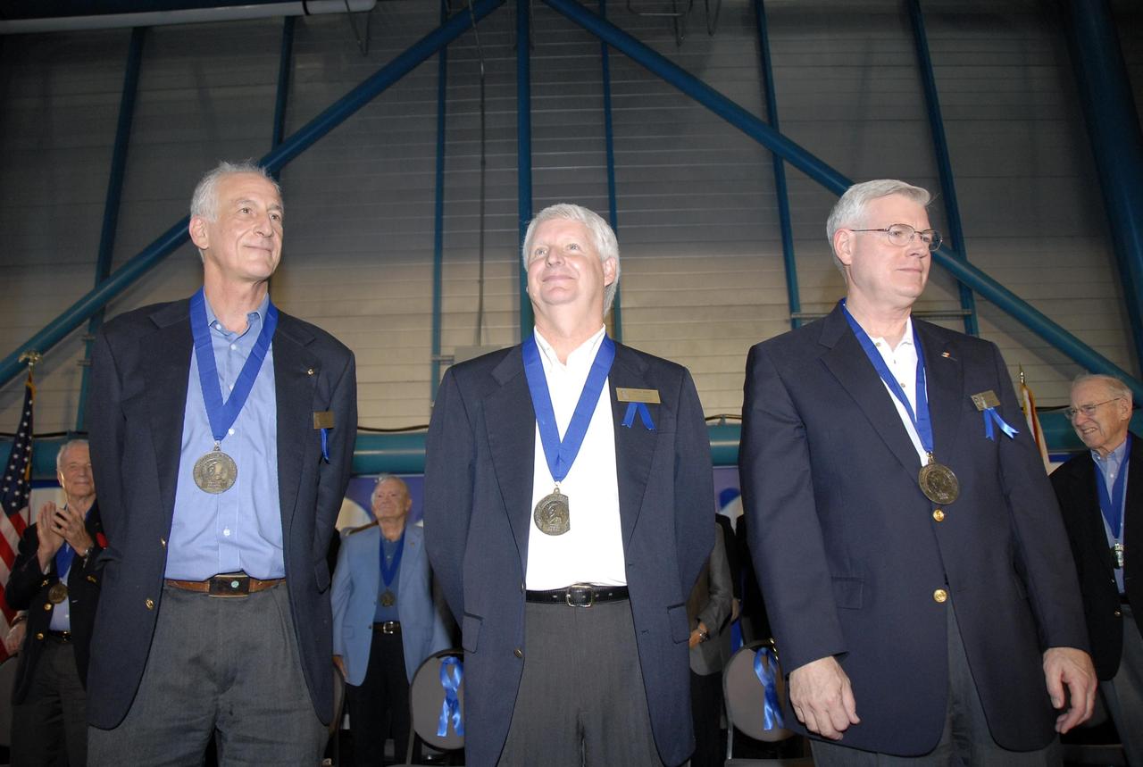 KENNEDY SPACE CENTER, FLA. --  The newest inductees to the U.S. Astronaut Hall of Fame stand tall of the ceremony.  From left are Jeffrey A. Hoffman, Steven A. Hawley and Michael L. Coats.  The May 5 induction has grown the number of space explorers enshrined in the Hall of Fame to 66. The ceremony was held at the Kennedy Space Center's Apollo/Saturn V Center.  Photo credit: NASA/Kim Shiflett
