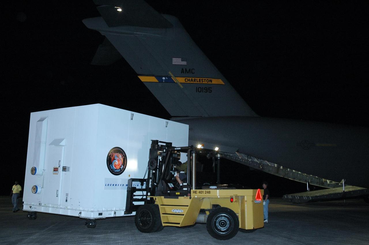 KENNEDY SPACE CENTER, FLA. --  On Kennedy Space Center's Shuttle Landing Facility, the crated Phoenix spacecraft is maneuvered away from the U.S. Air Force C-17 Globemaster III that delivered it. The crate will be transported to the Payload Hazardous Servicing Facility. The Phoenix mission is the first project in NASA's first openly competed program of Mars Scout missions. Phoenix will land in icy soils near the north polar permanent ice cap of Mars and explore the history of the water in these soils and any associated rocks, while monitoring polar climate. Landing is planned in May 2008 on arctic ground where a mission currently in orbit, Mars Odyssey, has detected high concentrations of ice just beneath the top layer of soil. It will serve as NASA's first exploration of a potential modern habitat on Mars and open the door to a renewed search for carbon-bearing compounds, last attempted with NASA’s Viking missions in the 1970s. A stereo color camera and a weather station will study the surrounding environment while the other instruments check excavated soil samples for water, organic chemicals and conditions that could indicate whether the site was ever hospitable to life. Microscopes can reveal features as small as one one-thousandth the width of a human hair. Launch of Phoenix aboard a Delta II rocket is targeted for Aug. 3 from Cape Canaveral Air Force Station in Florida.  Photo credit: NASA/Charisse Nahser