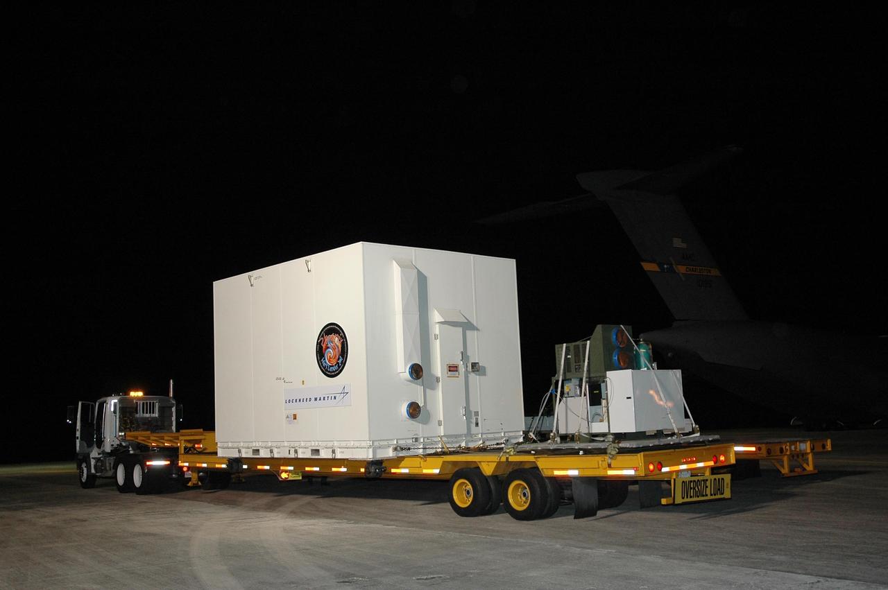 KENNEDY SPACE CENTER, FLA. --  After its arrival at Kennedy Space Center's Shuttle Landing Facility, the crated Phoenix spacecraft is secure on a flat bed truck for transportation to the Payload Hazardous Servicing Facility. The Phoenix mission is the first project in NASA's first openly competed program of Mars Scout missions. Phoenix will land in icy soils near the north polar permanent ice cap of Mars and explore the history of the water in these soils and any associated rocks, while monitoring polar climate. Landing is planned in May 2008 on arctic ground where a mission currently in orbit, Mars Odyssey, has detected high concentrations of ice just beneath the top layer of soil. It will serve as NASA's first exploration of a potential modern habitat on Mars and open the door to a renewed search for carbon-bearing compounds, last attempted with NASA’s Viking missions in the 1970s. A stereo color camera and a weather station will study the surrounding environment while the other instruments check excavated soil samples for water, organic chemicals and conditions that could indicate whether the site was ever hospitable to life. Microscopes can reveal features as small as one one-thousandth the width of a human hair. Launch of Phoenix aboard a Delta II rocket is targeted for Aug. 3 from Cape Canaveral Air Force Station in Florida.  Photo credit: NASA/Charisse Nahser