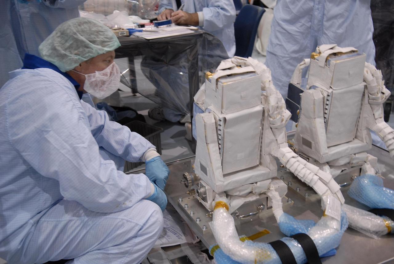KENNEDY SPACE CENTER, FLA. -- In the Space Station Processing Facility, STS-124 Mission Specialist Michael Fossum looks over equipment going to the International Space Station. Crew members of the mission are at KSC for equipment familiarization. The crew comprises Commander Mark Kelly, Pilot Kenneth Ham, and Mission Specialists Karen Nyberg, Ronald Garan, Fossum, Stephen Bowen and Akihiko Hoshide, who represents the Japanese Aerospace and Exploration Agency. The STS-124 mission is the second of three flights that will launch components to complete the Japanese pressurized module, the Kibo laboratory. The mission will include two spacewalks to install the new lab and its remote manipulator system. The lab's logistics module, which will have been installed in a temporary location during STS-123, will be attached to the new lab. The mission is scheduled to launch in 2008. Photo credit: NASA/Kim Shiflett