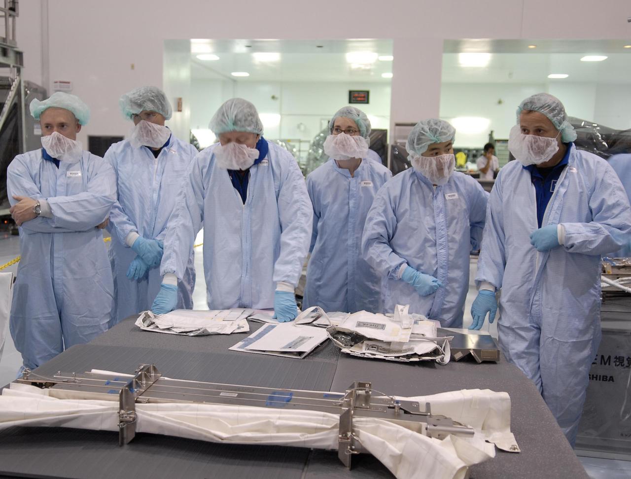 KENNEDY SPACE CENTER, FLA. -- Crew members of mission STS-124 are in the Space Station Processing Facility to look over equipment. Seen here are (left to right) Commander Mark Kelly and Mission Specialists Stephen Bowen, Michael Fossum, a technician, Akihiko Hoshide and Ronald Garan. Hoshide represents the Japanese Aerospace and Exploration Agency. The STS-124 mission is the second of three flights that will launch components to complete the Japanese pressurized module, the Kibo laboratory. The mission will include two spacewalks to install the new lab and its remote manipulator system. The lab's logistics module, which will have been installed in a temporary location during STS-123, will be attached to the new lab. The mission is scheduled to launch in 2008. Photo credit: NASA/Kim Shiflett