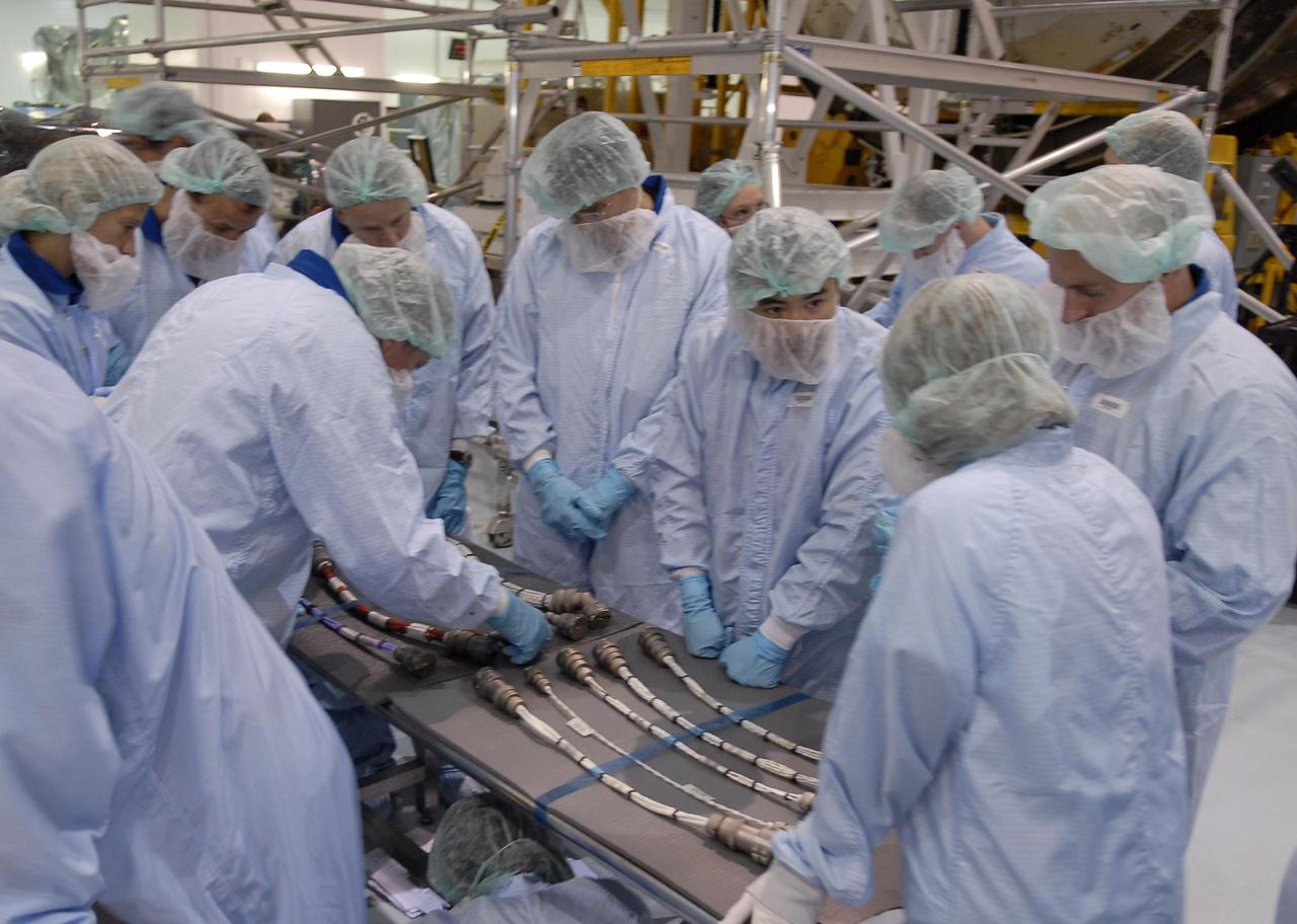 KENNEDY SPACE CENTER, FLA. -- Crew members of mission STS-124 are in the Space Station Processing Facility to look over equipment. The crew comprises Commander Mark Kelly, Pilot Kenneth Ham, and Mission Specialists Karen Nyberg, Ronald Garan, Michael Fossum, Stephen Bowen and Akihiko Hoshide, who represents the Japanese Aerospace and Exploration Agency. The STS-124 mission is the second of three flights that will launch components to complete the Japanese pressurized module, the Kibo laboratory. The mission will include two spacewalks to install the new lab and its remote manipulator system. The lab's logistics module, which will have been installed in a temporary location during STS-123, will be attached to the new lab. The mission is scheduled to launch in 2008. Photo credit: NASA/Kim Shiflett