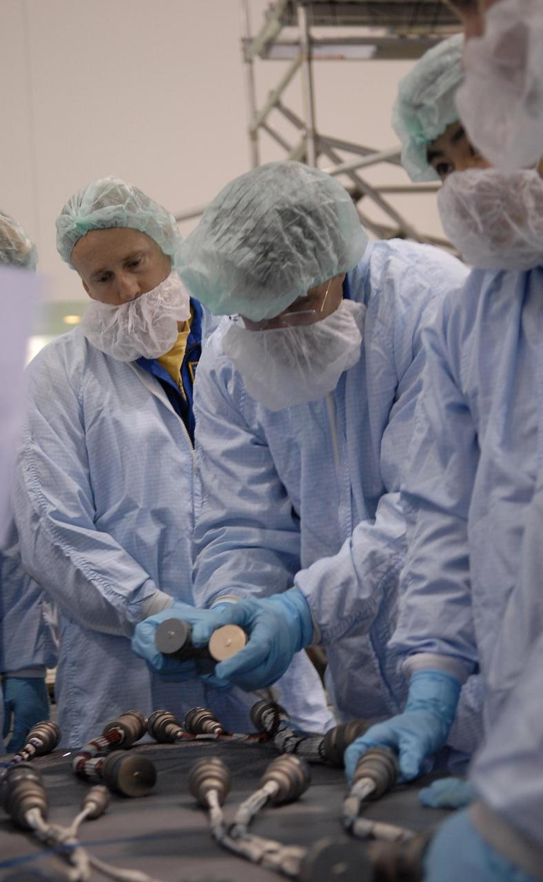 KENNEDY SPACE CENTER, FLA. -- Crew members of mission STS-124 are in the Space Station Processing Facility to look over equipment. Here they watch a demonstration using some of the equipment. At left is Commander Mark Kelly. Other crew members are Pilot Kenneth Ham, and Mission Specialists Karen Nyberg, Ronald Garan, Michael Fossum, Stephen Bowen and Akihiko Hoshide, who represents the Japanese Aerospace and Exploration Agency. The STS-124 mission is the second of three flights that will launch components to complete the Japanese pressurized module, the Kibo laboratory. The mission will include two spacewalks to install the new lab and its remote manipulator system. The lab's logistics module, which will have been installed in a temporary location during STS-123, will be attached to the new lab. The mission is scheduled to launch in 2008. Photo credit: NASA/Kim Shiflett