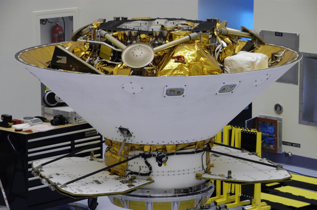 KENNEDY SPACE CENTER, FLA. --  This closeup shows the Phoenix Mars Lander spacecraft nestled inside the backshell.  The spacecraft will undergo spin testing on the spin table to which it is attached in the Payload Hazardous Servicing Facility. The Phoenix mission is the first project in NASA's first openly competed program of Mars Scout missions. Phoenix will land in icy soils near the north polar permanent ice cap of Mars and explore the history of the water in these soils and any associated rocks, while monitoring polar climate. Landing is planned in May 2008 on arctic ground where a mission currently in orbit, Mars Odyssey, has detected high concentrations of ice just beneath the top layer of soil. It will serve as NASA's first exploration of a potential modern habitat on Mars and open the door to a renewed search for carbon-bearing compounds, last attempted with NASA’s Viking missions in the 1970s. A stereo color camera and a weather station will study the surrounding environment while the other instruments check excavated soil samples for water, organic chemicals and conditions that could indicate whether the site was ever hospitable to life. Microscopes can reveal features as small as one one-thousandth the width of a human hair. Launch of Phoenix aboard a Delta II rocket is targeted for Aug. 3 from Cape Canaveral Air Force Station in Florida.   Photo credit: NASA/George Shelton