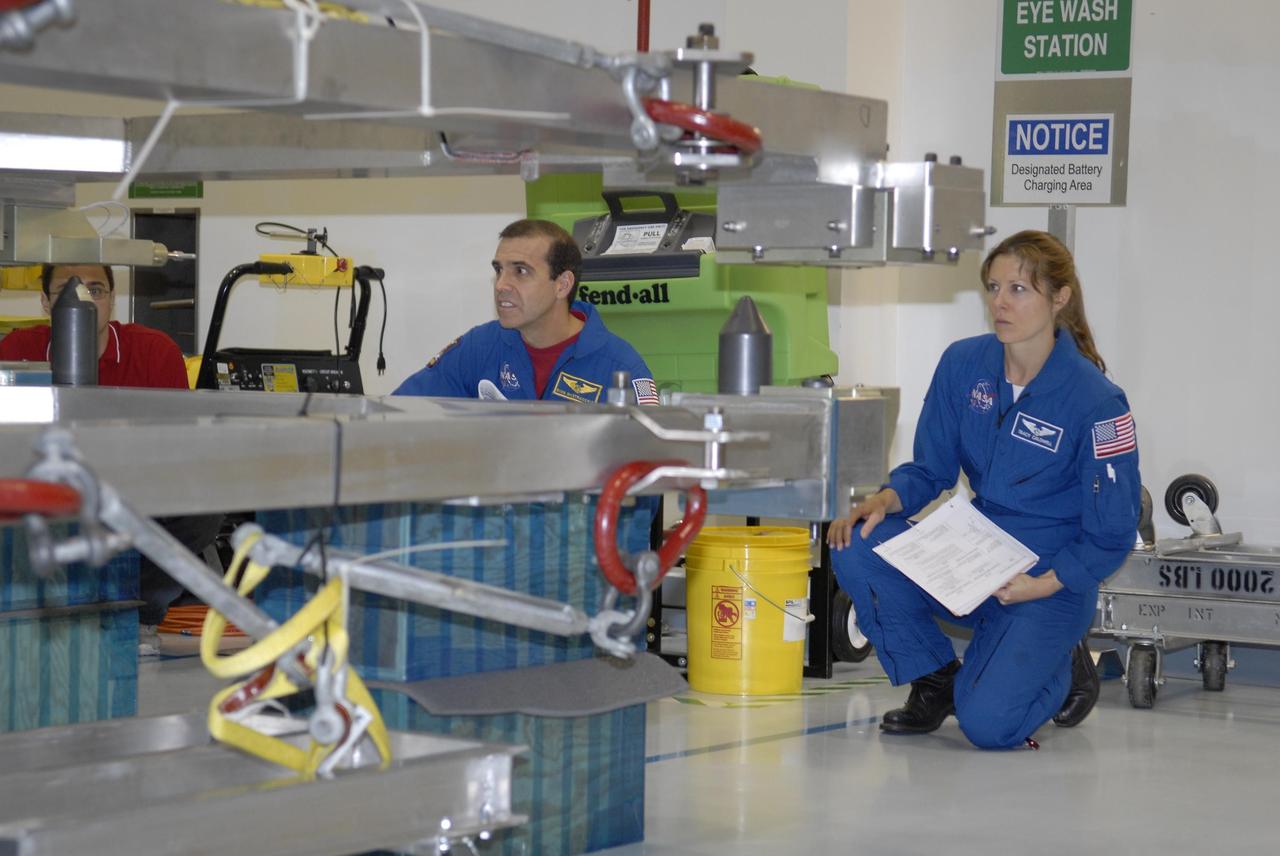 KENNEDY SPACE CENTER, FLA. -- The STS-118 crew members look over parts of the mission payload, the S5 integrated truss, in the Space Station Processing Facility during crew equipment interface test activities. Seen here are Mission Specialists Richard Mastracchio (left) and Tracy Caldwell. The crew comprises Commander Scott Kelly, Pilot Charles Hobaugh, and Mission Specialists Dr. Dafydd Williams, Barbara Morgan, Mastracchio, Caldwell and Benjamin Drew. Williams is with the Canadian Space Agency. The STS-118 mission will be delivering the third starboard truss segment, the ITS S5, to the International Space Station, and a SPACEHAB Single Cargo module with supplies and equipment. Launch aboard Space Shuttle Endeavour is targeted for August. Photo credit: NASA/Kim Shiflett