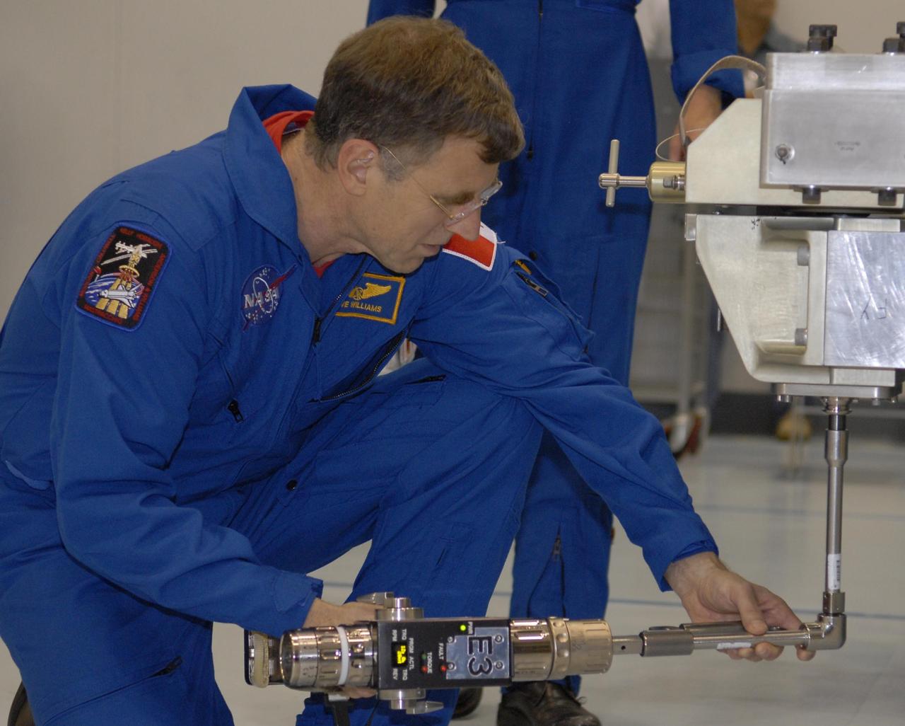 KENNEDY SPACE CENTER, FLA. --The STS-118 crew members look over parts of the mission payload, the S5 integrated truss, in the Space Station Processing Facility during crew equipment interface test activities. Seen here is Mission Specialist Dr. Dafydd Williams, getting hands-on experience. The crew comprises Commander Scott Kelly, Pilot Charles Hobaugh, and Mission Specialists Williams, Barbara Morgan, Richard Mastracchio, Tracy Caldwell and Benjamin Drew. Williams is with the Canadian Space Agency. The STS-118 mission will be delivering the third starboard truss segment, the ITS S5, to the International Space Station, and a SPACEHAB Single Cargo module with supplies and equipment. Launch aboard Space Shuttle Endeavour is targeted for August. Photo credit: NASA/Kim Shiflett