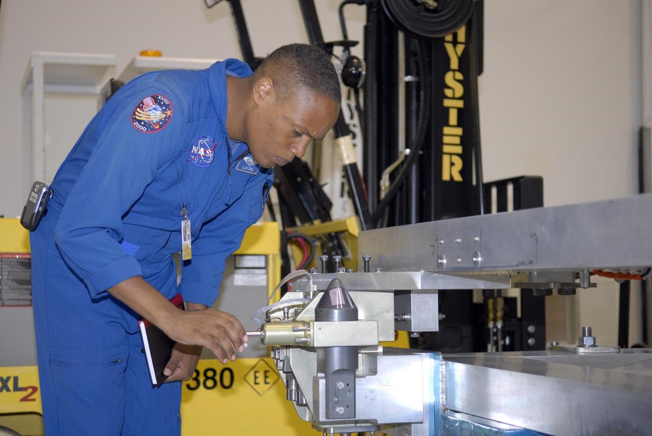 KENNEDY SPACE CENTER, FLA. -- The STS-118 crew members look over parts of the mission payload, the S5 integrated truss, in the Space Station Processing Facility during crew equipment interface test activities. Seen here is Mission Specialist Benjamin Drew, who will be making his first space shuttle flight. The crew comprises Commander Scott Kelly, Pilot Charles Hobaugh, and Mission Specialists Dr. Dafydd Williams, Barbara Morgan, Richard Mastracchio, Tracy Caldwell and Drew. Williams is with the Canadian Space Agency. The STS-118 mission will be delivering the third starboard truss segment, the ITS S5, to the International Space Station, and a SPACEHAB Single Cargo module with supplies and equipment. Launch aboard Space Shuttle Endeavour is targeted for August. Photo credit: NASA/Kim Shiflett