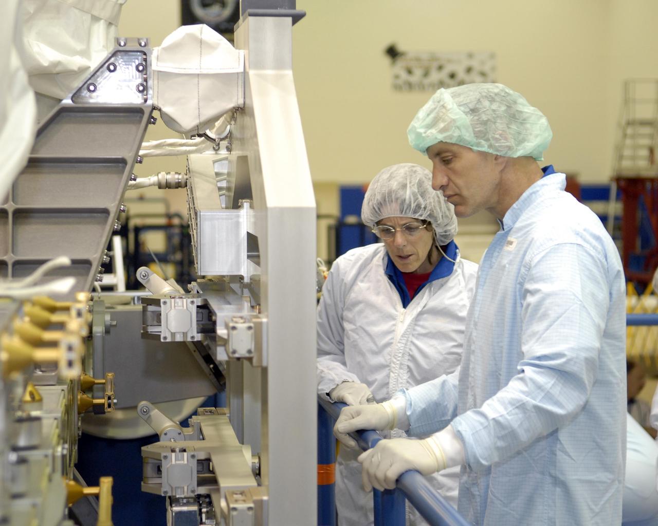 KENNEDY SPACE CENTER, FLA. --  The STS-118 crew members look over parts of the mission payload, the control moment gyroscope, at SPACEHAB during crew equipment interface test activities.  Seen here are Mission Specialist Barbara Morgan and Pilot Charles Hobaugh.  The crew comprises Commander Scott Kelly, Hobaugh, and Mission Specialists Dr. Dafydd Williams, Morgan, Richard Mastracchio, Tracy Caldwell and Benjamin Drew. Williams is with the Canadian Space Agency.  The STS-118 mission will be delivering the third starboard truss segment, the ITS S5, to the International Space Station, and a SPACEHAB Single Cargo module with supplies and equipment.  Launch aboard Space Shuttle Endeavour is targeted for August.   Photo credit: NASA/Kim Shiflett