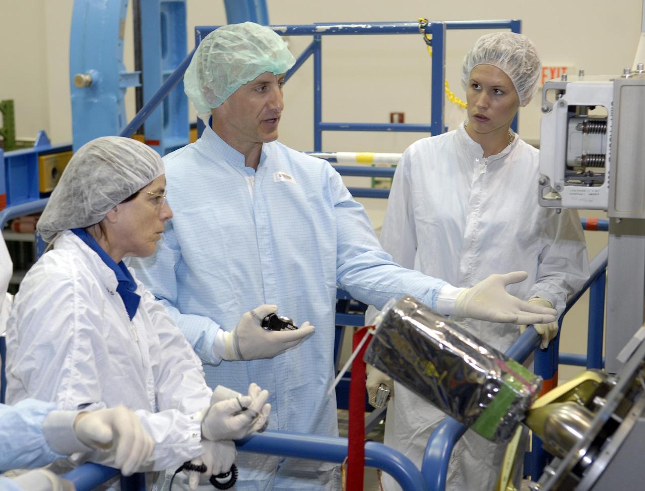 KENNEDY SPACE CENTER, FLA. --   The STS-118 crew members look over parts of the mission payload, the control moment gyroscope, at SPACEHAB during crew equipment interface test activities.  Seen here are Mission Specialist Barbara Morgan (left) and Pilot Charles Hobaugh (center).  The crew comprises Commander Scott Kelly, Hobaugh, and Mission Specialists Dr. Dafydd Williams, Morgan, Richard Mastracchio, Tracy Caldwell and Benjamin Drew. Williams is with the Canadian Space Agency.  The STS-118 mission will be delivering the third starboard truss segment, the ITS S5, to the International Space Station, and a SPACEHAB Single Cargo module with supplies and equipment.  Launch aboard Space Shuttle Endeavour is targeted for August.   Photo credit: NASA/Kim Shiflett