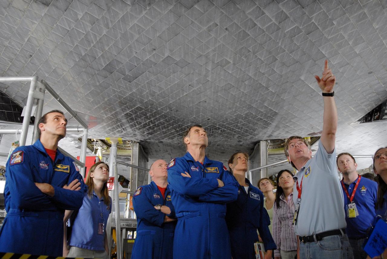 KENNEDY SPACE CENTER, FLA. --     During crew equipment interface test activities, members of the STS-118 crew look over the orbiter Endeavour in Orbiter Processing Facility bay 2.  At left is Mission Specialist Richard Mastracchio; in the center are Commander Scott Kelly and Mission Specialists Dr. Dafydd Williams and Tracy Caldwell.  The STS-118 mission will be delivering the third starboard truss segment, the ITS S5, to the International Space Station, as well as the SPACEHAB single cargo module filled with supplies and equipment.  Launch aboard Space Shuttle Endeavour is targeted for Aug. 9.   Photo credit: NASA/Kim Shiflett