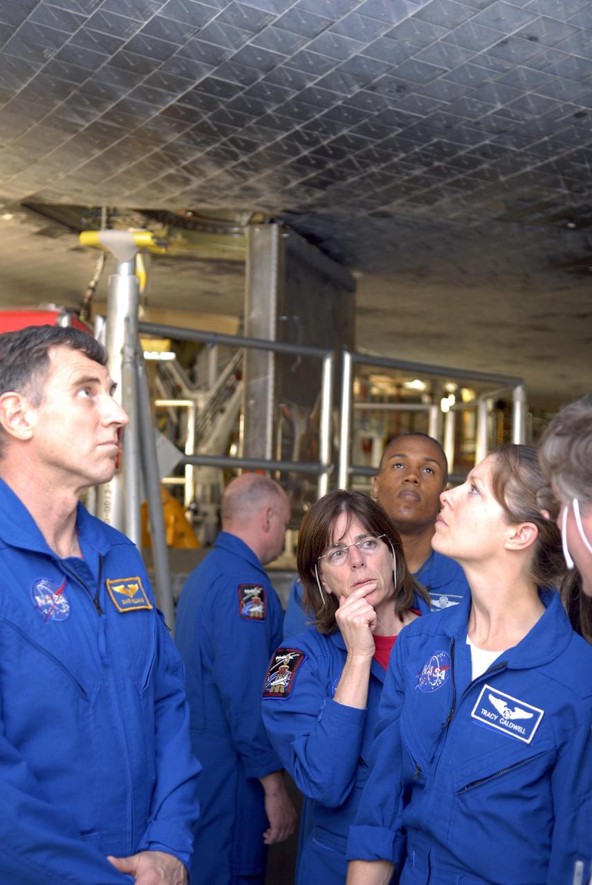 KENNEDY SPACE CENTER, FLA. --     During crew equipment interface test activities, members of the STS-118 crew look over the orbiter Endeavour in Orbiter Processing Facility bay 2.  From left are Mission Specialist Dr. Dafydd Williams, Commander Scott Kelly, and Mission Specialists Barbara Morgan, Benjamin Drew and Tracy Caldwell. The STS-118 mission will be delivering the third starboard truss segment, the ITS S5, to the International Space Station, as well as the SPACEHAB single cargo module filled with supplies and equipment.  Launch aboard Space Shuttle Endeavour is targeted for Aug. 9.   Photo credit: NASA/Kim Shiflett