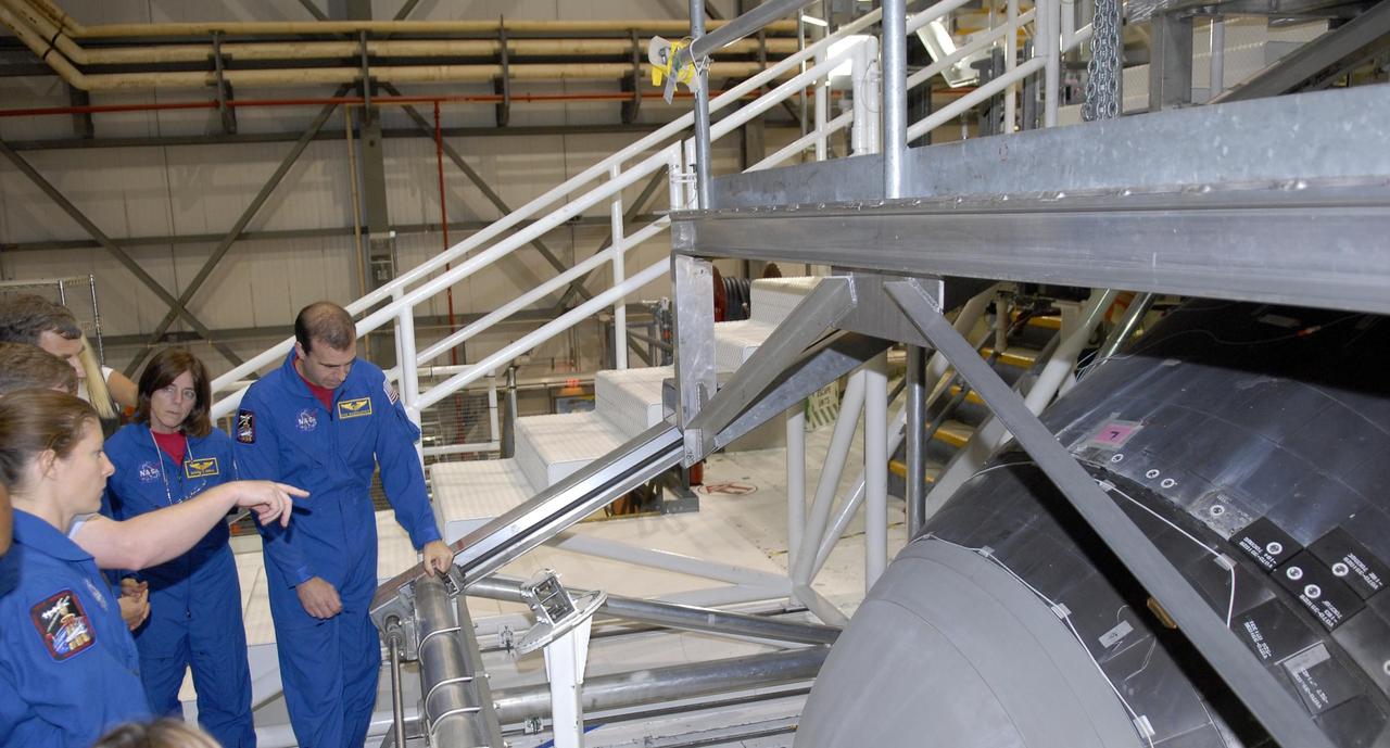 KENNEDY SPACE CENTER, FLA. --   During crew equipment interface test activities, members of the STS-118 crew look over the orbiter Endeavour in Orbiter Processing Facility bay 2.  Seen here are (from left), Mission Specialists Tracy Caldwell, Barbara Morgan and Richard Mastrocchio. The STS-118 mission will be delivering the third starboard truss segment, the ITS S5, to the International Space Station, as well as the SPACEHAB single cargo module filled with supplies and equipment.  Launch aboard Space Shuttle Endeavour is targeted for Aug. 9.   Photo credit: NASA/Kim Shiflett