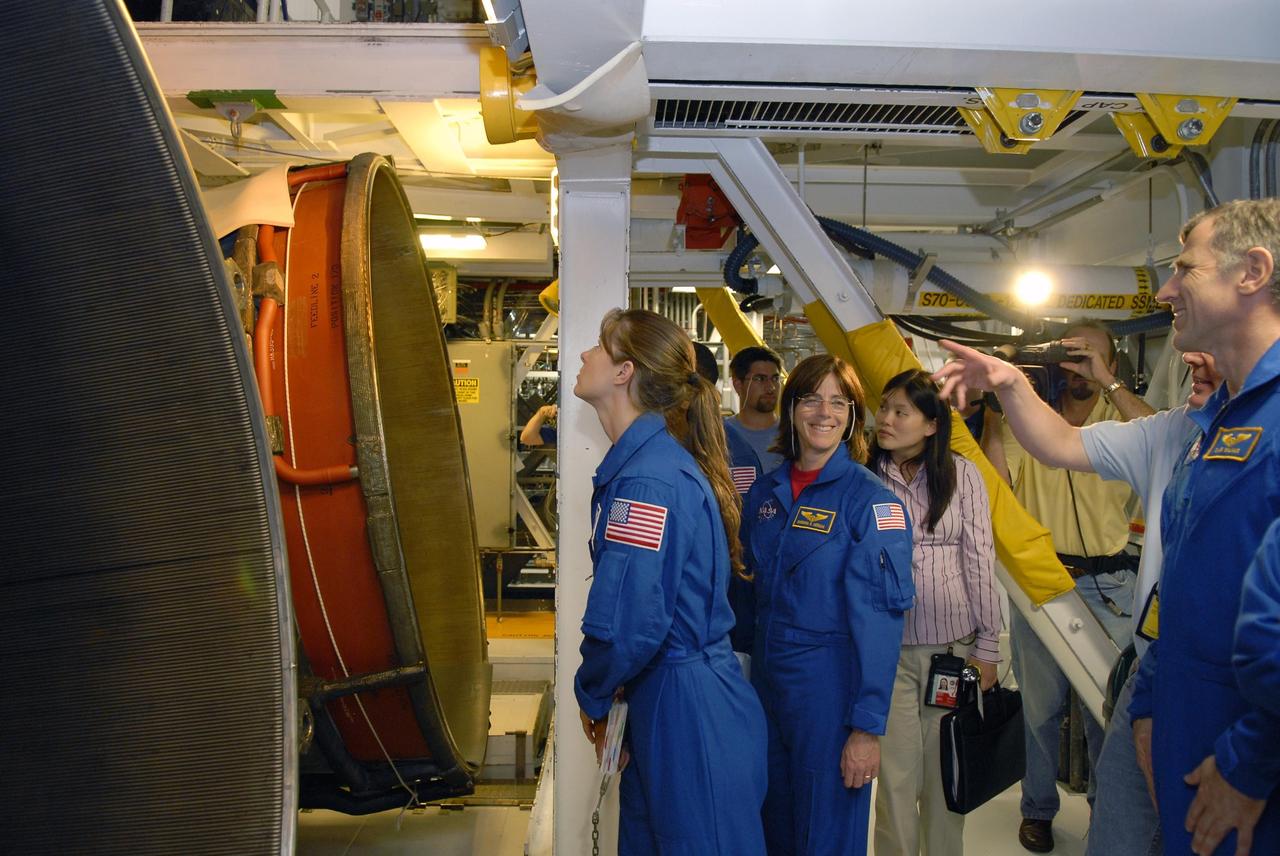 KENNEDY SPACE CENTER, FLA. --    In Orbiter Processing Facility bay 2, members of the STS-118 crew look at the main engines on the orbiter Endeavour during crew equipment interface test activities.  Seen here are (from left) Mission Specialists Tracy Caldwell, Barbara Morgan and (far right) Dr. Dafydd Williams. The STS-118 mission will be delivering the third starboard truss segment, the ITS S5, to the International Space Station, as well as the SPACEHAB single cargo module filled with supplies and equipment.  Launch aboard Space Shuttle Endeavour is targeted for Aug. 9.   Photo credit: NASA/Kim Shiflett