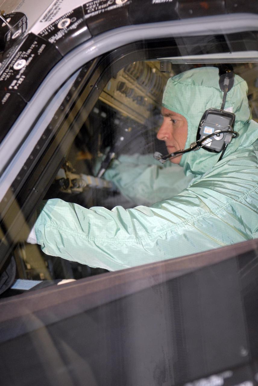 KENNEDY SPACE CENTER, FLA. --   During crew equipment interface test activities at KSC, STS-118 Commander Scott Kelly checks the cockpit windshield of orbiter Endeavour, which is in Orbiter Processing Facility bay 3. The STS-118 mission will be delivering the third starboard truss segment, the ITS S5, to the International Space Station, as well as the SPACEHAB single cargo module filled with supplies and equipment.  Launch aboard Space Shuttle Endeavour is targeted for Aug. 9.   Photo credit: NASA/Kim Shiflett