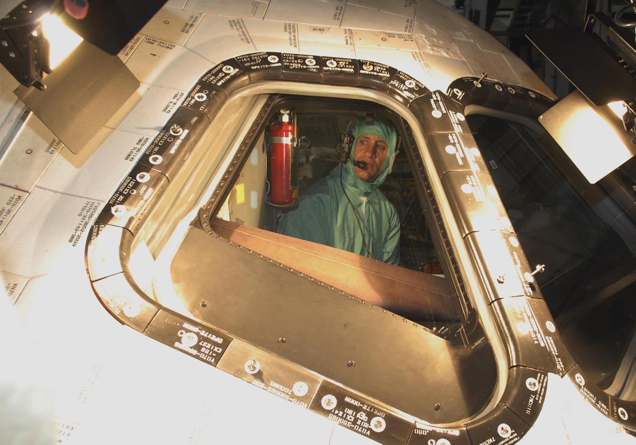 KENNEDY SPACE CENTER, FLA. --  During crew equipment interface test activities at KSC, STS-118 Pilot Charles Hobaugh looks out the starboard cockpit window of orbiter Endeavour, which is in Orbiter Processing Facility bay 3. The STS-118 mission will be delivering the third starboard truss segment, the ITS S5, to the International Space Station, as well as the SPACEHAB single cargo module filled with supplies and equipment.  Launch aboard Space Shuttle Endeavour is targeted for Aug. 9.   Photo credit: NASA/Kim Shiflett