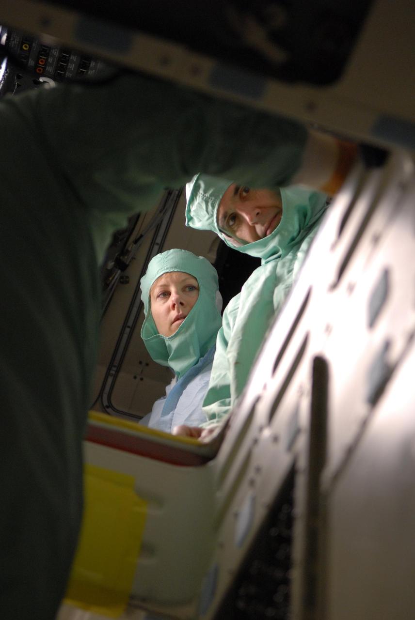 KENNEDY SPACE CENTER, FLA. --   During crew equipment interface test activities at KSC, STS-118 Mission Specialists Tracy Caldwell (left) and Richard Mastrocchio look inside the orbiter Endeavour, which is in Orbiter Processing Facility bay 3. The STS-118 mission will be delivering the third starboard truss segment, the ITS S5, to the International Space Station, as well as the SPACEHAB single cargo module filled with supplies and equipment.  Launch aboard Space Shuttle Endeavour is targeted for Aug. 9.   Photo credit: NASA/Kim Shiflett